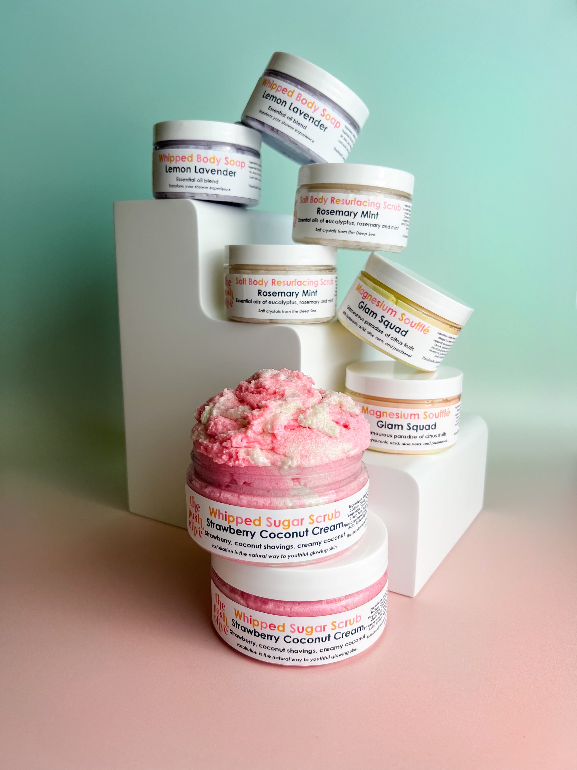 tall white steps holding several open pink and white sugar scrub jars 