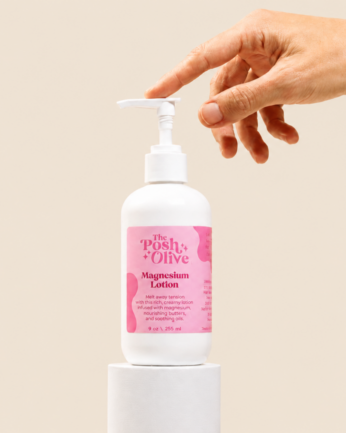 The Posh Olive Magnesium Lotion in white pump bottle with hand pressing dispense