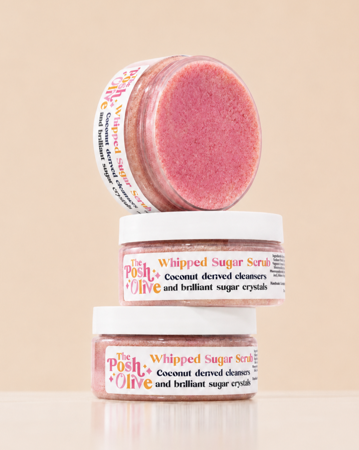 The Posh Olive Whipped Sugar Scrub jars stacked with pink sugar scrub visible